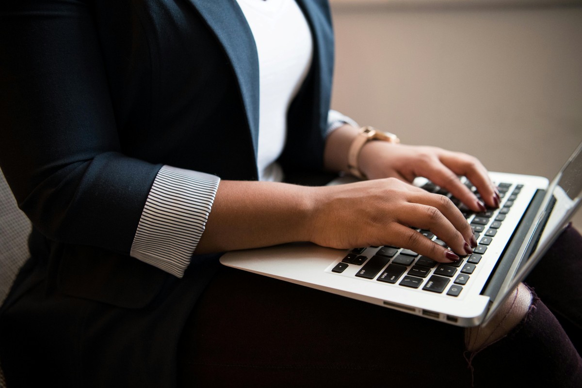 Business woman typing on laptop