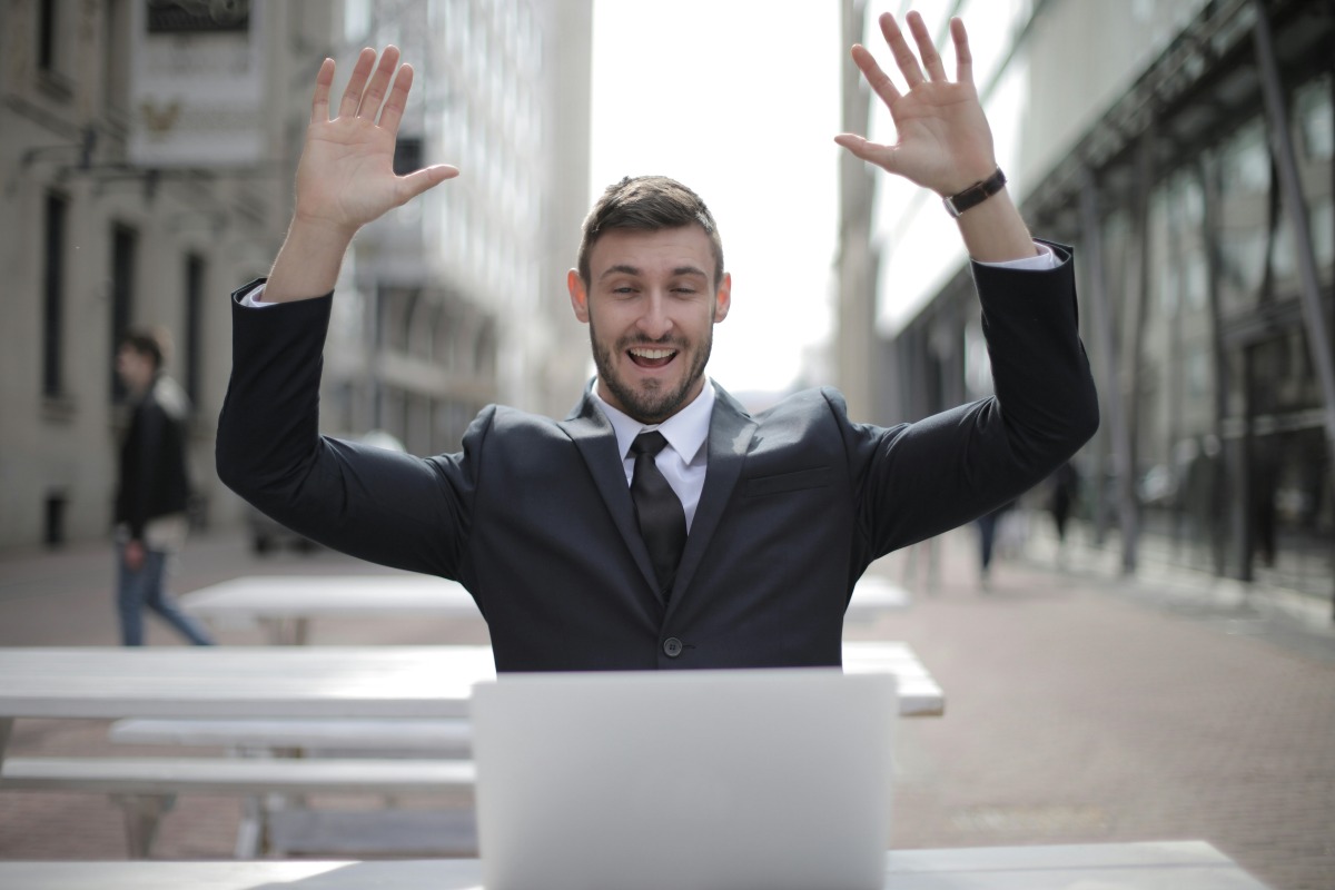 Man celebrating at a laptop