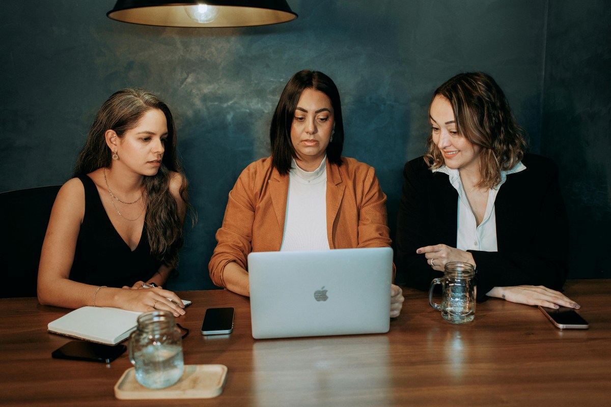 Three women working together on a laptop