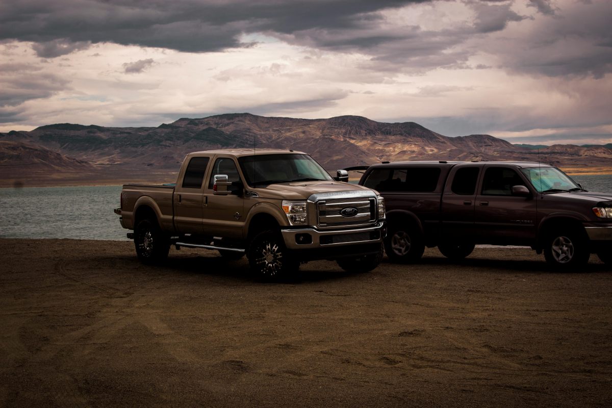 Trucks parked by a lake