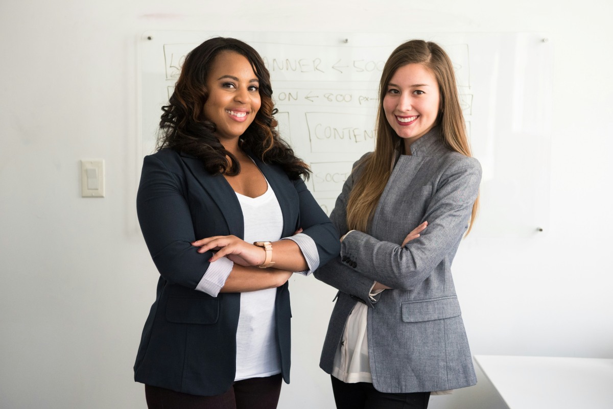 Two business woman stnading with arms crossed