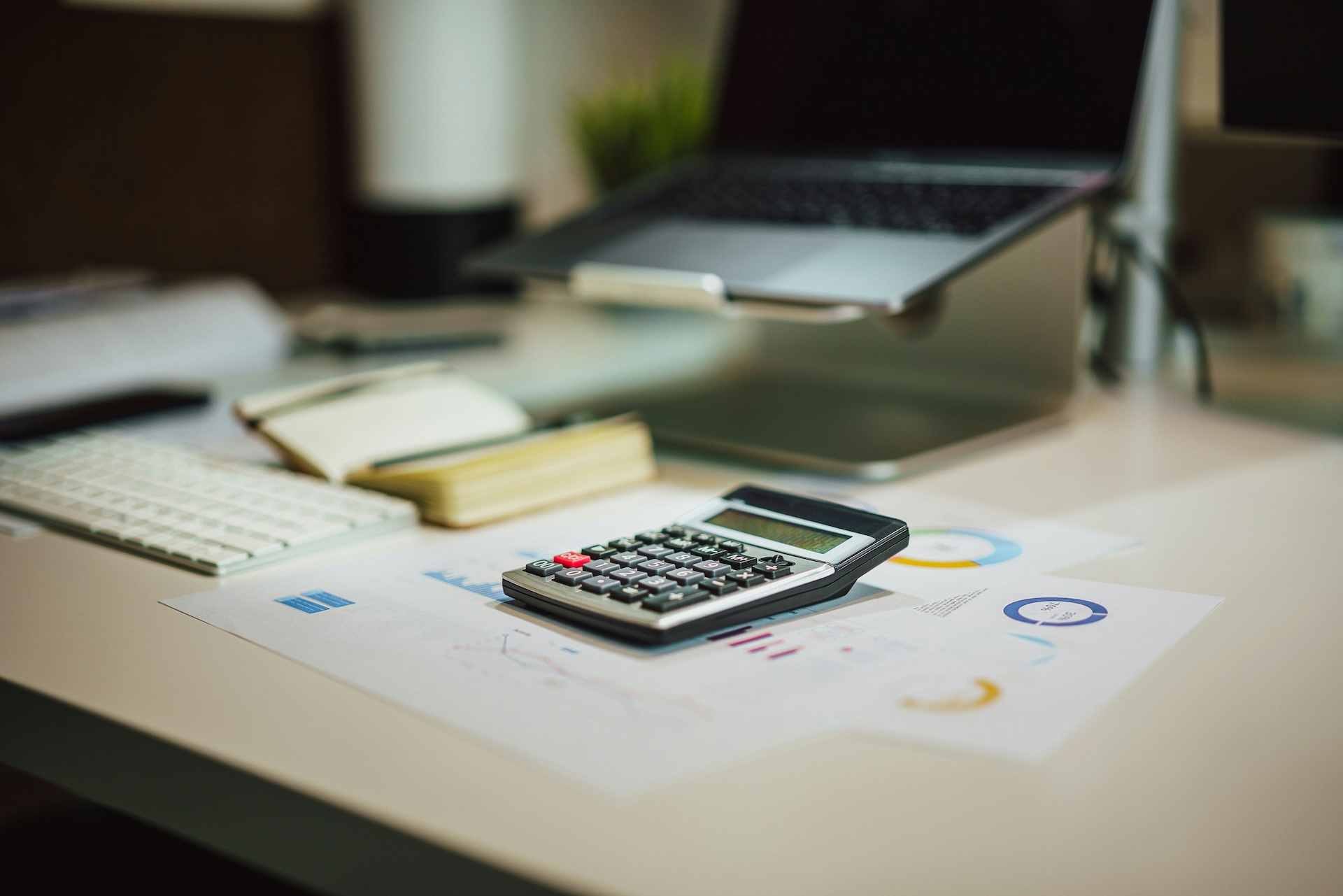 calculator on business desk as part of a business acquisition loan