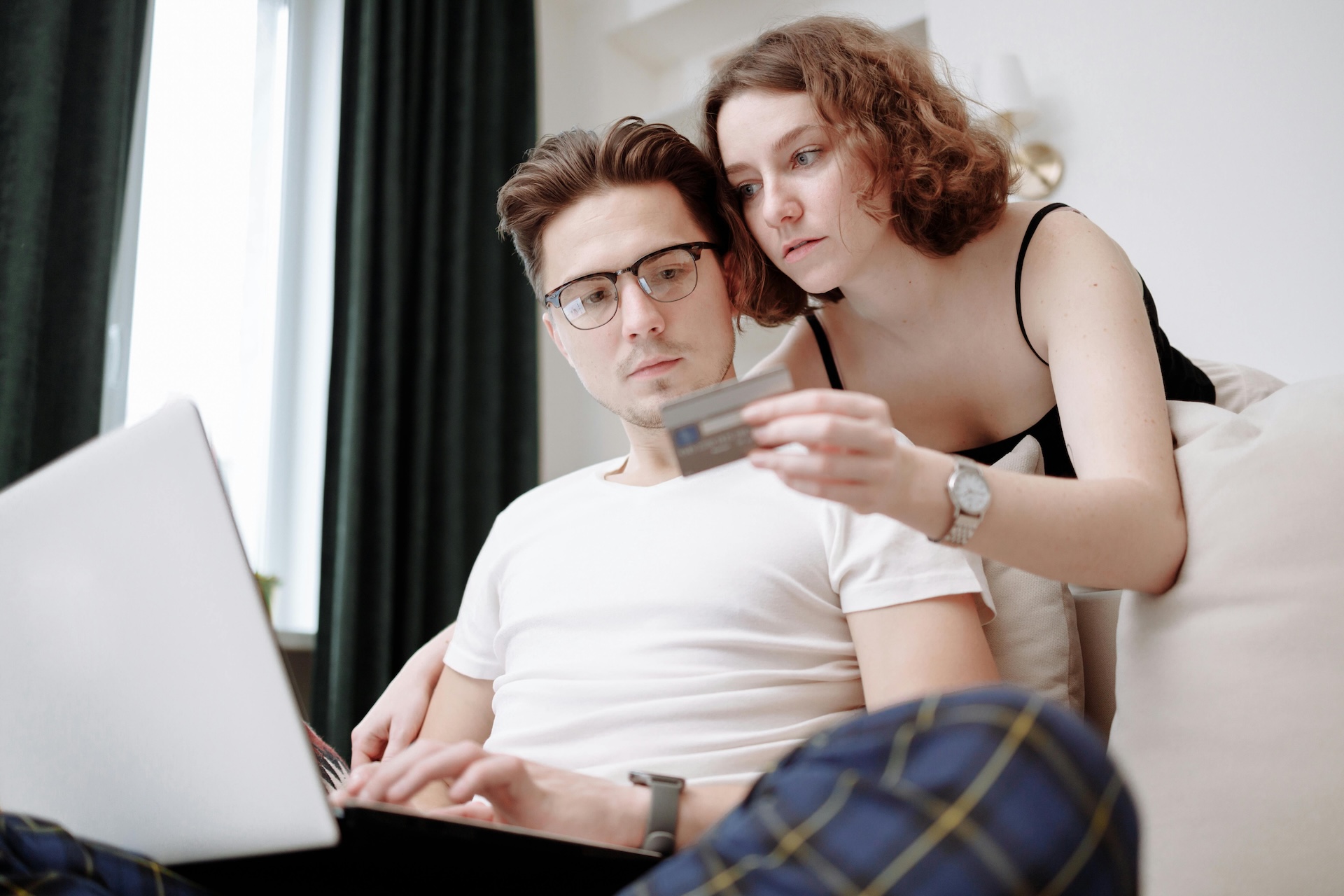 couple look over credit score determining if they can apply for a business loan for bad credit