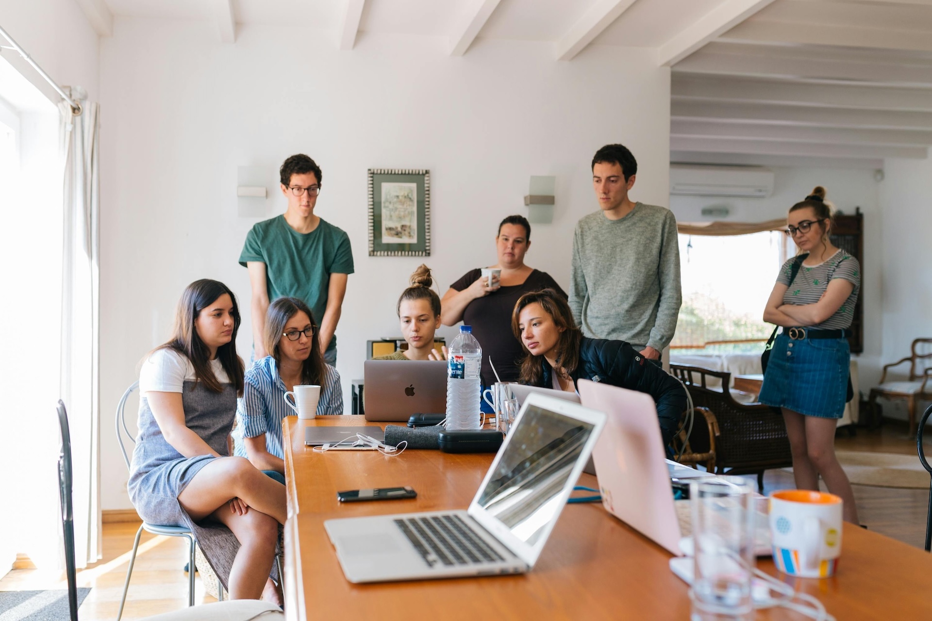 group of people watching amazon business on laptop