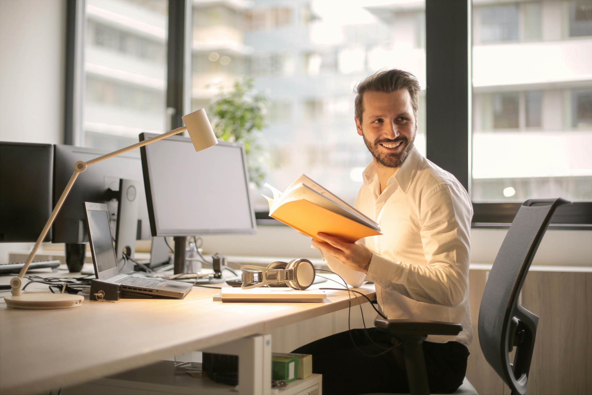 man at desk smiling because of shopify capital