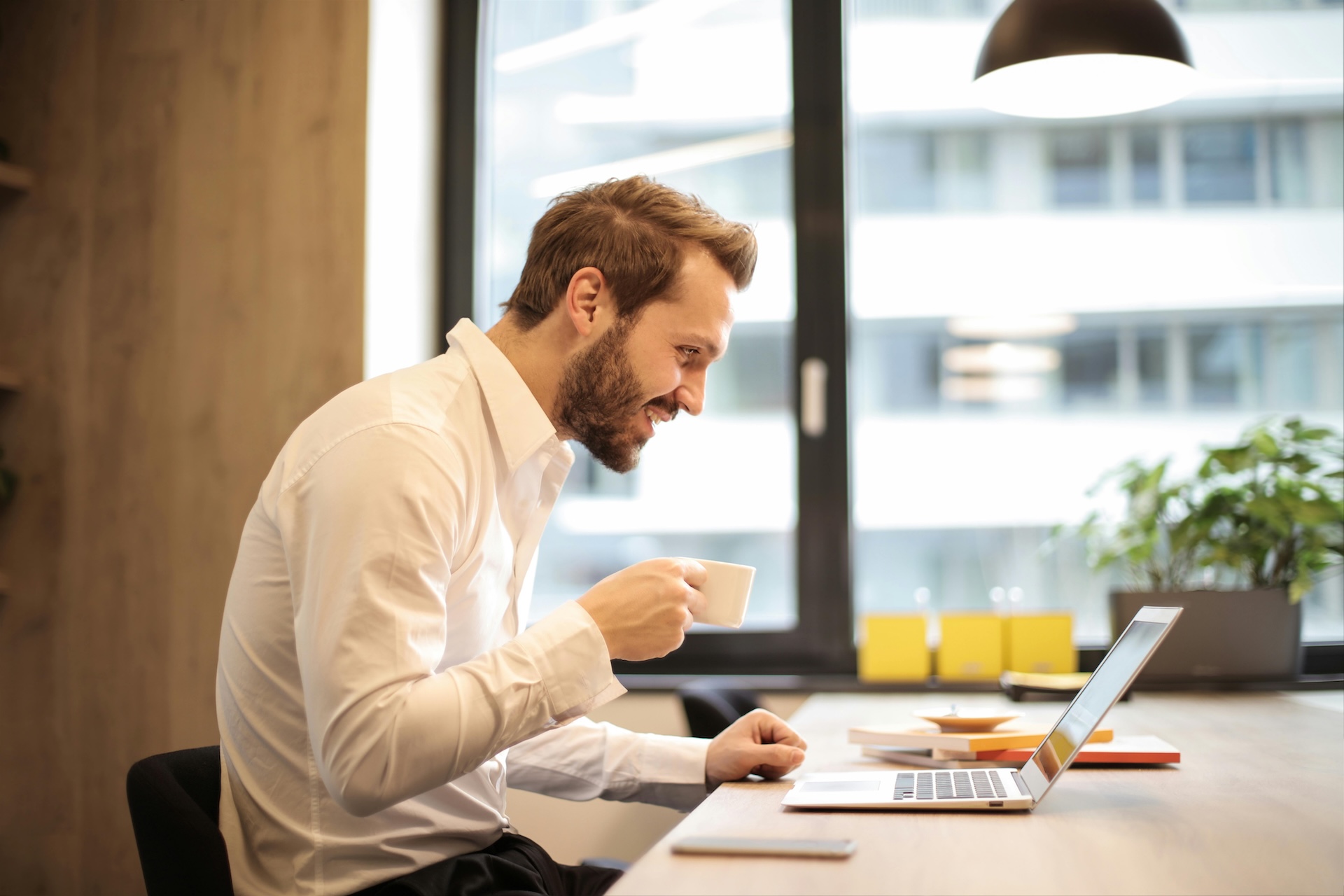 man looking at options for business loans for bad credit on laptop