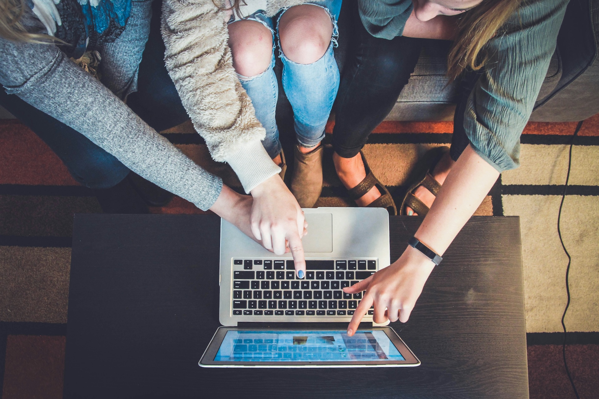 three people pointing at laptop on amazon business