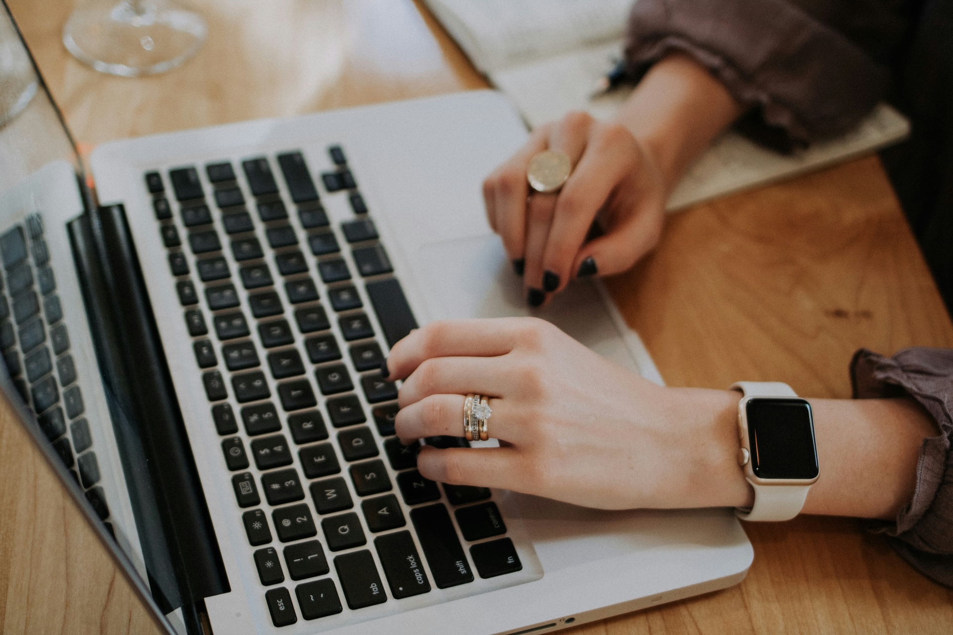 woman typing on laptop updating business information